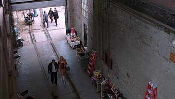 Movie still from “Analyze That” (2002), directed by Harold Ramis – A couple of people walking down a street; Extreme Wide shot, High angle