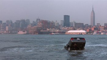 Movie still from “Analyze That” (2002), directed by Harold Ramis – A boat in a body of water with a city in the background; Extreme Wide shot, High angle