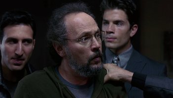 Movie still from “Analyze That” (2002), directed by Harold Ramis – A man with a goatee and a beard and a man with a goatee; Close Up shot, Over the shoulder angle