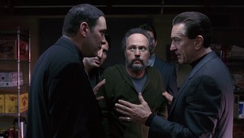 Movie still from “Analyze That” (2002), directed by Harold Ramis – A group of men standing next to each other in a room; Medium shot, Over the shoulder angle