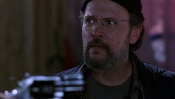 Movie still from “Analyze That” (2002), directed by Harold Ramis – A man with a beard wearing glasses and a hat; Close Up shot, Low angle