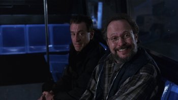 Movie still from “Analyze That” (2002), directed by Harold Ramis – Two men sitting next to each other on a bus; Medium shot, Over the shoulder angle