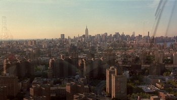 Movie still from “Analyze That” (2002), directed by Harold Ramis – An aerial view of a large city with many tall buildings; Extreme Wide shot, High angle