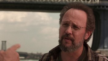 Movie still from “Analyze That” (2002), directed by Harold Ramis – A person with a beard wearing glasses; Close Up shot, Low angle