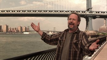 Movie still from “Analyze That” (2002), directed by Harold Ramis – A man standing next to a body of water; Medium shot, Low angle
