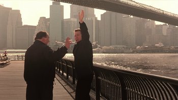 Movie still from “Analyze That” (2002), directed by Harold Ramis – Two men standing next to each other on a bridge; Wide shot, Over the shoulder angle