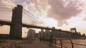 Movie still from “Analyze That” (2002), directed by Harold Ramis – People are walking on a boardwalk near a bridge; Extreme Wide shot, Low angle