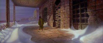 Movie still from “Anastasia” (1997), directed by Gary Goldman – A man walking in front of a brick building; Wide shot, High angle