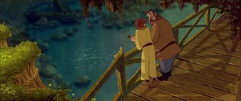 Movie still from “Anastasia” (1997), directed by Gary Goldman – A man and a woman standing on a wooden bridge; Wide shot, High angle
