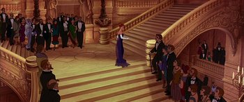 Movie still from “Anastasia” (1997), directed by Gary Goldman – A group of people standing around a staircase; Wide shot, High angle