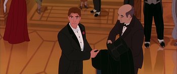Movie still from “Anastasia” (1997), directed by Gary Goldman – A man in a tuxedo is holding a cell phone; Medium shot, Over the shoulder angle