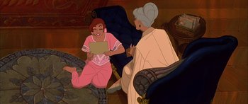 Movie still from “Anastasia” (1997), directed by Gary Goldman – Two women sitting on the floor and one of them is holding a piece of paper; Medium shot, High angle