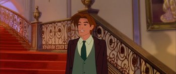 Movie still from “Anastasia” (1997), directed by Gary Goldman – A man in a suit and tie standing in front of a staircase; Medium shot, High angle