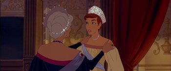 Movie still from “Anastasia” (1997), directed by Gary Goldman – A woman is putting a tiara on a woman's shoulder; Medium shot, Over the shoulder angle