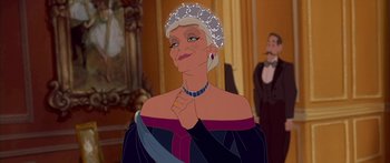 Movie still from “Anastasia” (1997), directed by Gary Goldman – An old woman is wearing a tiara and holding her hands to her chest; Close Up shot, Over the shoulder angle