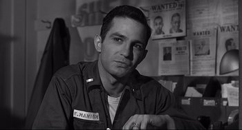 Movie still from “Anatomy of a Murder” (1959), directed by Otto Preminger – Black and white photograph of a man in a military uniform; Close Up shot, Low angle