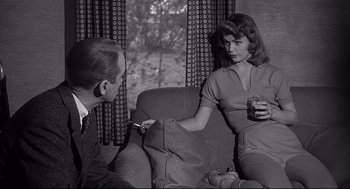 Movie still from “Anatomy of a Murder” (1959), directed by Otto Preminger – A man and a woman sitting on a couch; Medium shot, Over the shoulder angle