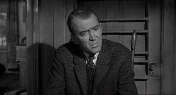 Movie still from “Anatomy of a Murder” (1959), directed by Otto Preminger – An older man in a suit and tie; Close Up shot, Over the shoulder angle