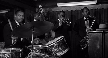 Movie still from “Anatomy of a Murder” (1959), directed by Otto Preminger – A black and white photo of a man playing the drums; Medium shot, Low angle