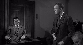 Movie still from “Anatomy of a Murder” (1959), directed by Otto Preminger – Two men in suits and ties in an office setting; Medium shot, Over the shoulder angle
