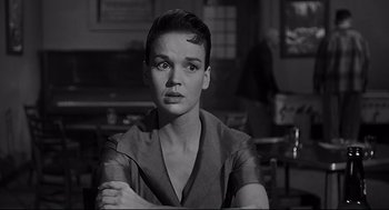Movie still from “Anatomy of a Murder” (1959), directed by Otto Preminger – A black - and - white photo of a woman with short hair; Close Up shot, Low angle