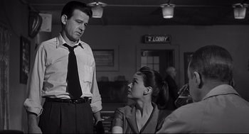 Movie still from “Anatomy of a Murder” (1959), directed by Otto Preminger – A man and a woman are talking to each other in a restaurant; Medium shot, Over the shoulder angle