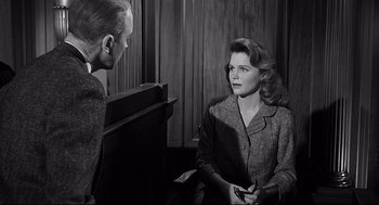 Movie still from “Anatomy of a Murder” (1959), directed by Otto Preminger – An old photo of a man and a woman talking to each other; Medium shot, Over the shoulder angle