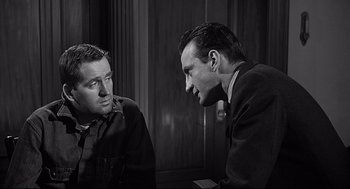 Movie still from “Anatomy of a Murder” (1959), directed by Otto Preminger – Two men are talking to each other in a room; Medium shot, Over the shoulder angle