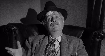 Movie still from “Anatomy of a Murder” (1959), directed by Otto Preminger – A man with a bandage on his head; Close Up shot, Low angle