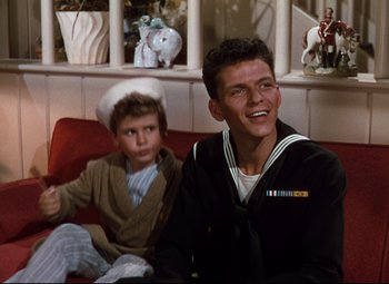 Movie still from “Anchors Aweigh” (1945), directed by Joseph Barbera – Two young men sitting on a couch in a living room; Medium shot, High angle