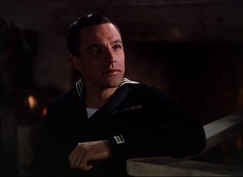 Movie still from “Anchors Aweigh” (1945), directed by Joseph Barbera – A man in a navy uniform looking at the camera; Close Up shot, Low angle