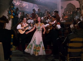 Movie still from “Anchors Aweigh” (1945), directed by Joseph Barbera – A group of people in a room with instruments; Wide shot, Low angle