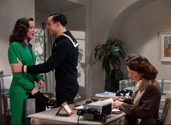 Movie still from “Anchors Aweigh” (1945), directed by Joseph Barbera – Two women and a man are talking to each other in a room; Medium shot, Over the shoulder angle
