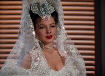 Movie still from “Anchors Aweigh” (1945), directed by Joseph Barbera – A woman in a white dress with a veil on her head; Close Up shot, Low angle