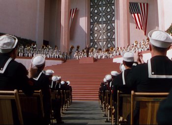 Movie still from “Anchors Aweigh” (1945), directed by Joseph Barbera – A group of people sitting on top of a set of steps; Extreme Wide shot, High angle