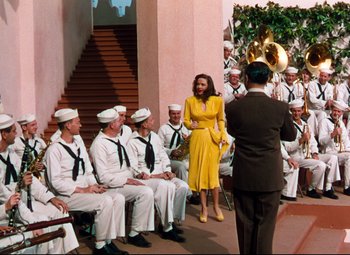 Movie still from “Anchors Aweigh” (1945), directed by Joseph Barbera – A group of people dressed in sailor outfits; Wide shot, High angle