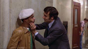 Movie still from “And Justice for All” (1979), directed by Norman Jewison – A man in a suit and a hat touching another man in a suit; Close Up shot, Over the shoulder angle