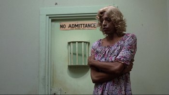 Movie still from “And Justice for All” (1979), directed by Norman Jewison – A person standing in front of a door with a sign on it; Medium shot, Over the shoulder angle