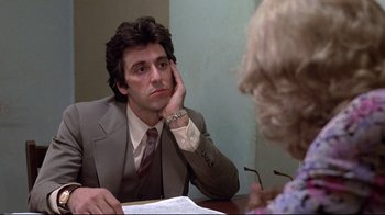 Movie still from “And Justice for All” (1979), directed by Norman Jewison – A man sitting at a table in front of an older woman; Close Up shot, Over the shoulder angle