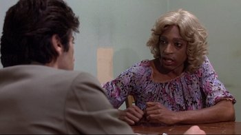 Movie still from “And Justice for All” (1979), directed by Norman Jewison – Two people sitting at a table talking to each other; Close Up shot, Over the shoulder angle