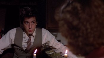 Movie still from “And Justice for All” (1979), directed by Norman Jewison – A man in a vest and tie sitting in front of two candles; Close Up shot, Over the shoulder angle