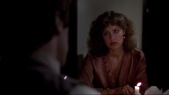 Movie still from “And Justice for All” (1979), directed by Norman Jewison – A woman sitting in front of a man in front of a mirror; Close Up shot, Over the shoulder angle
