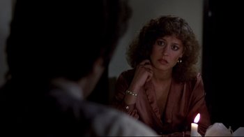 Movie still from “And Justice for All” (1979), directed by Norman Jewison – A woman sitting in front of a mirror looking sad; Close Up shot, Over the shoulder angle