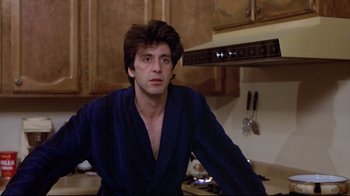 Movie still from “And Justice for All” (1979), directed by Norman Jewison – A man sitting in a kitchen wearing a blue robe; Close Up shot, Over the shoulder angle
