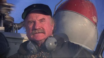 Movie still from “And Justice for All” (1979), directed by Norman Jewison – An older man with a mustache wearing a hat and ear muffs; Close Up shot, Low angle