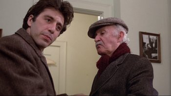 Movie still from “And Justice for All” (1979), directed by Norman Jewison – Two men standing next to each other in front of a door; Close Up shot, Over the shoulder angle