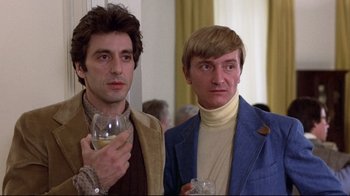 Movie still from “And Justice for All” (1979), directed by Norman Jewison – Two men standing next to each other holding wine glasses; Close Up shot, Low angle