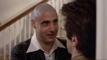 Movie still from “And Justice for All” (1979), directed by Norman Jewison – A man with a bald head talking to another man; Close Up shot, Over the shoulder angle