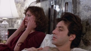 Movie still from “And Justice for All” (1979), directed by Norman Jewison – A man and a woman sitting on a bed; Close Up shot, Over the shoulder angle