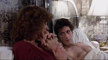 Movie still from “And Justice for All” (1979), directed by Norman Jewison – A man and a woman looking in the same mirror; Close Up shot, Over the shoulder angle